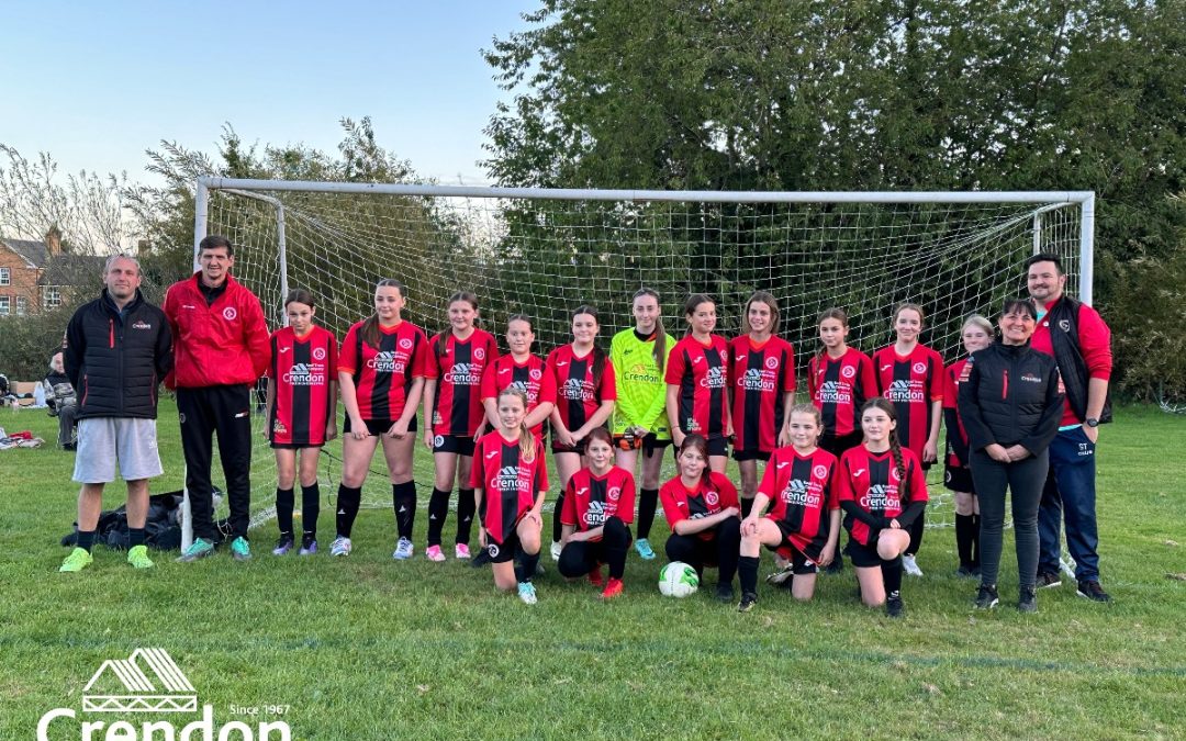 Children's football team in red and black kit.