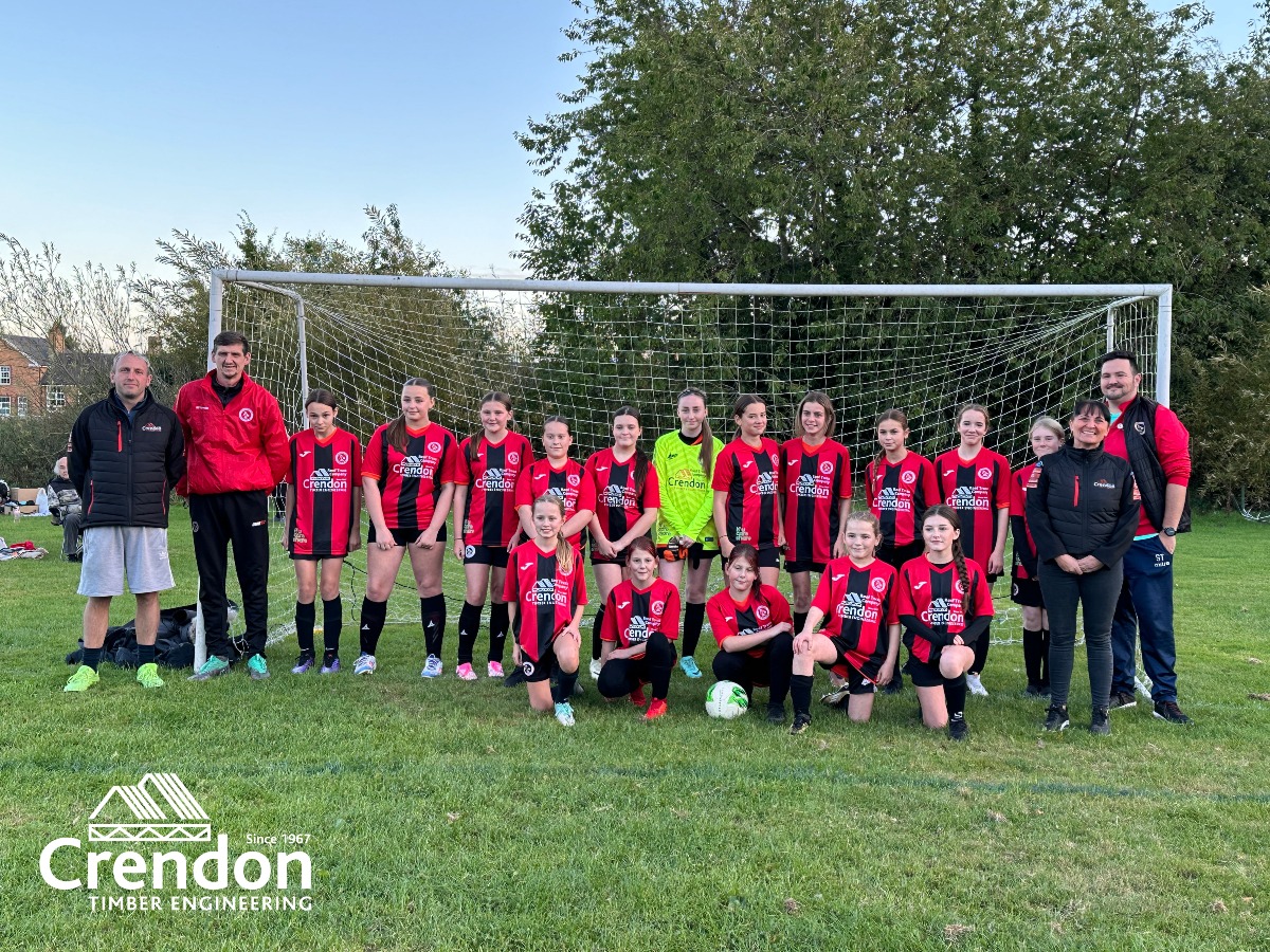 Children's football team in red and black kit.