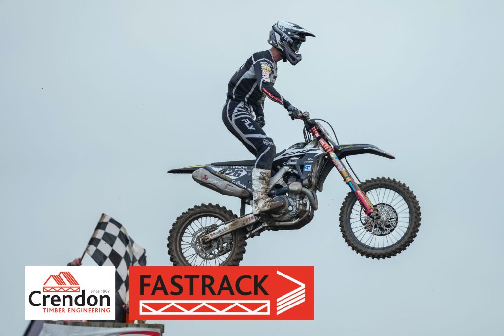 Motorcross rider jumping through air on bike