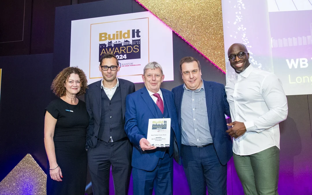 Five people on stage accepting an award