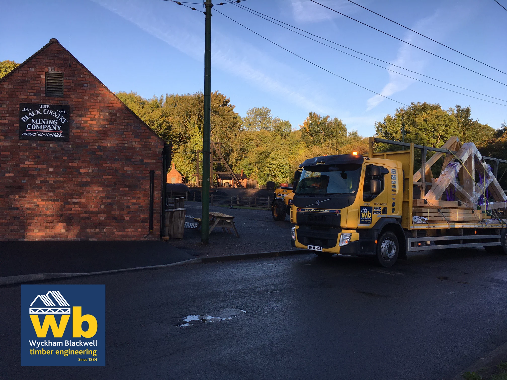 Wyckham Blackwell lorry next to brick building