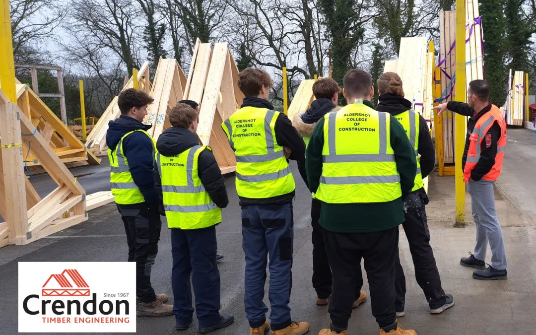 Group of men in hi-vis jackets in wood yard