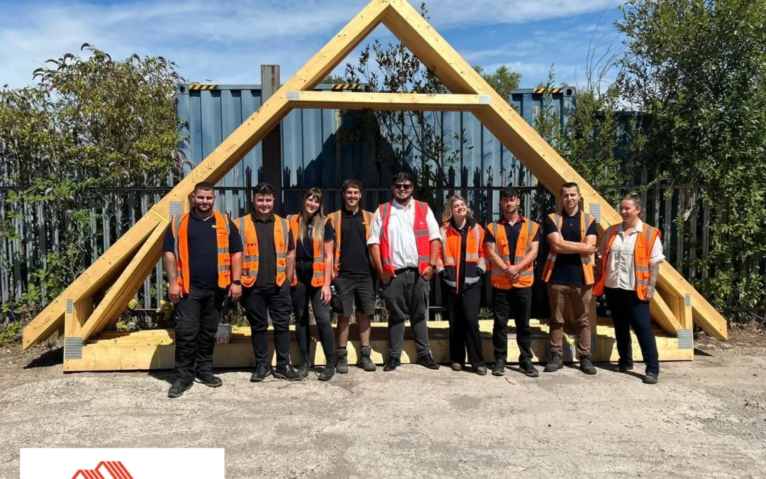 Group of people stood in front of an attic roof truss