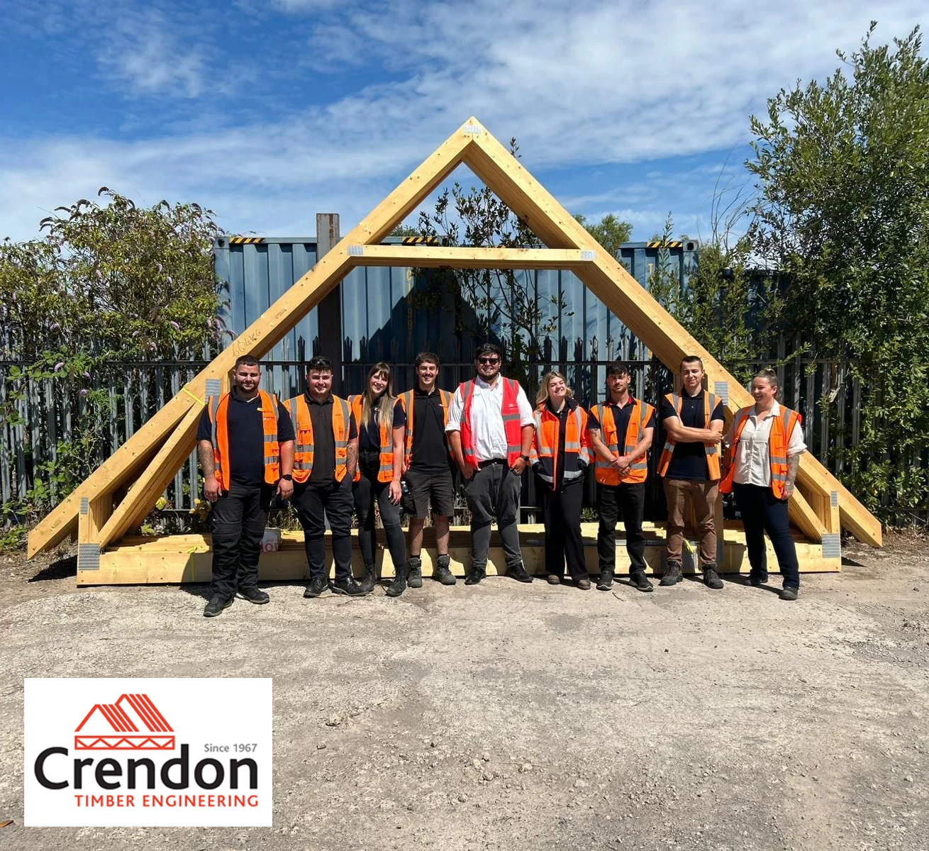 Group of people stood in front of an attic roof truss