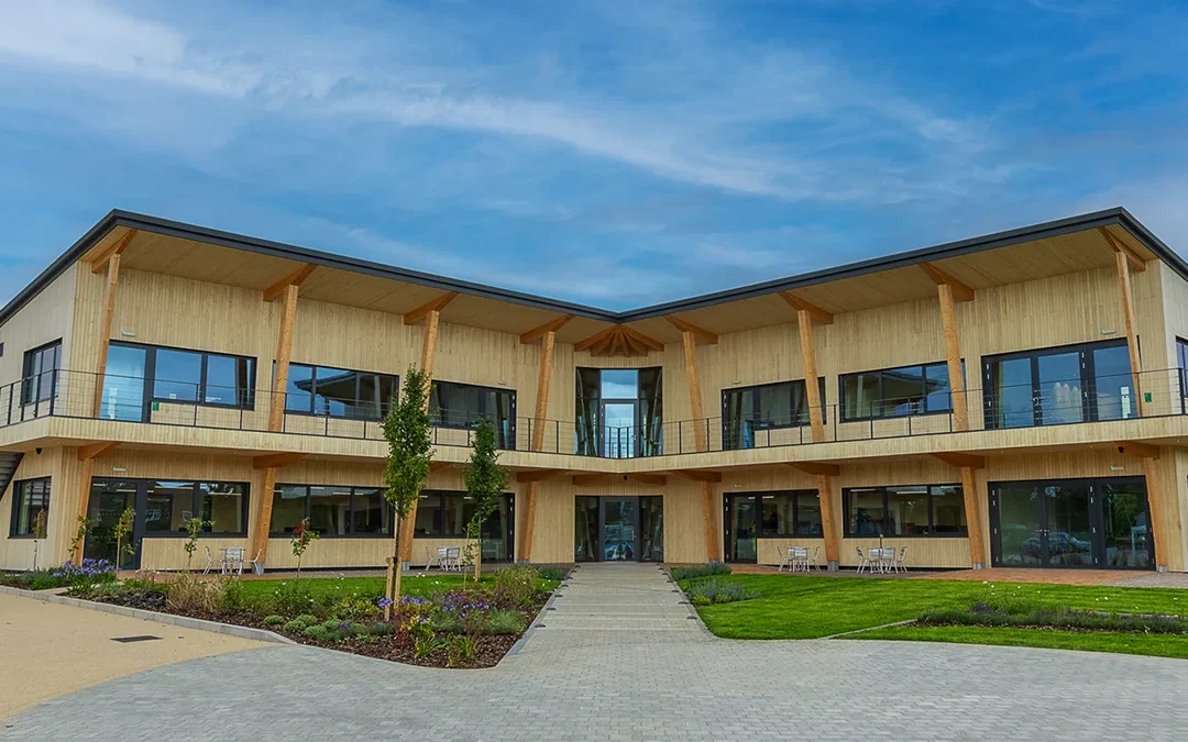 L shaped wooden clad building from the outside