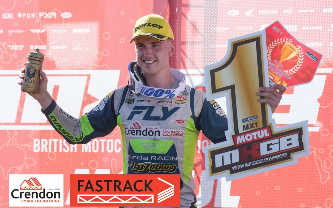 Conrad Mewse holding a number 1 position sign