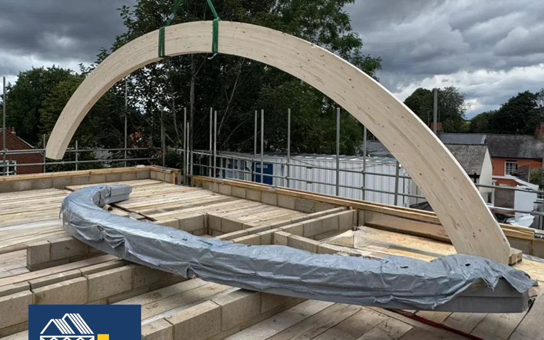 Curved glulam beam being lifted onto building site