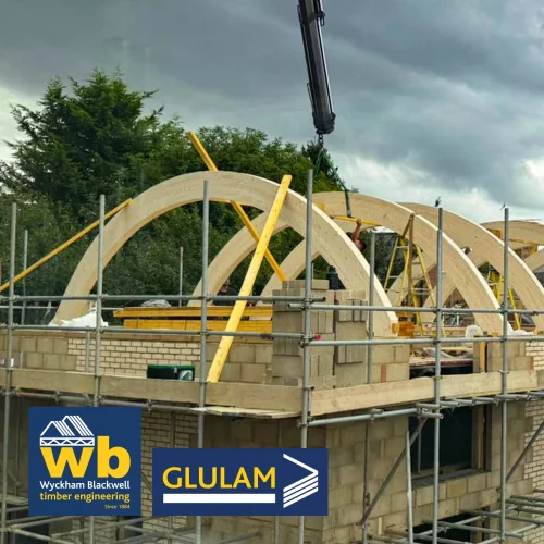 Multiple curved glulam beams on building site