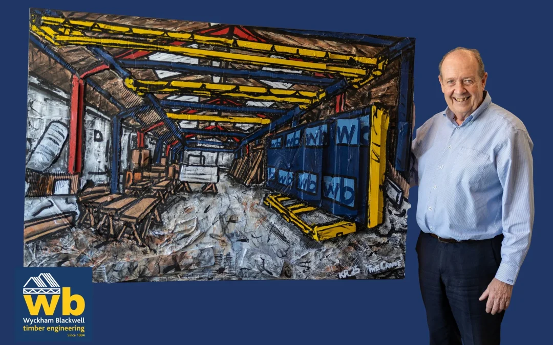 Man in shirt holding up artwork