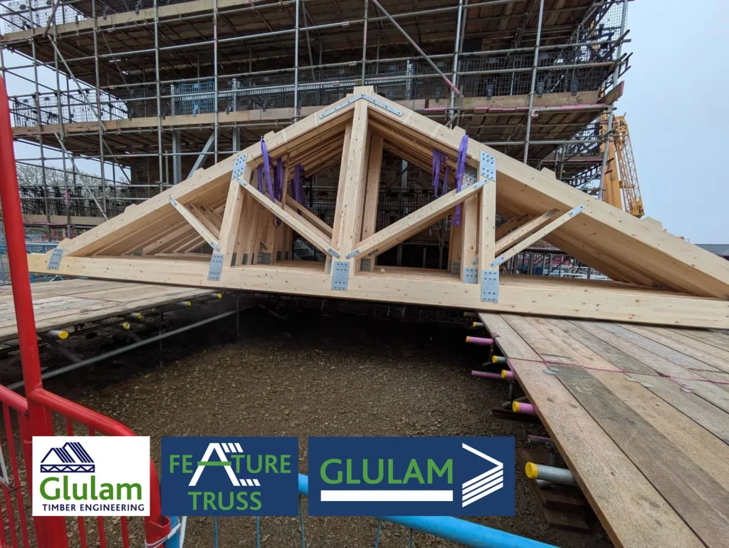 Front view of feature truss lent against scaffolded building