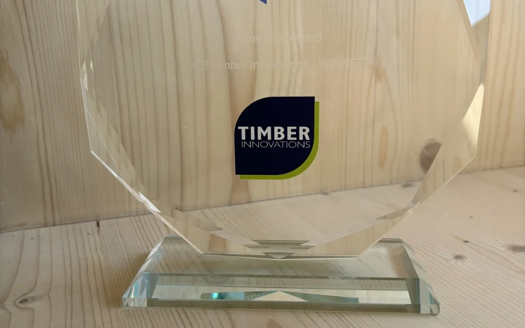 Close up of glass trophy with Timber Innovations logo on