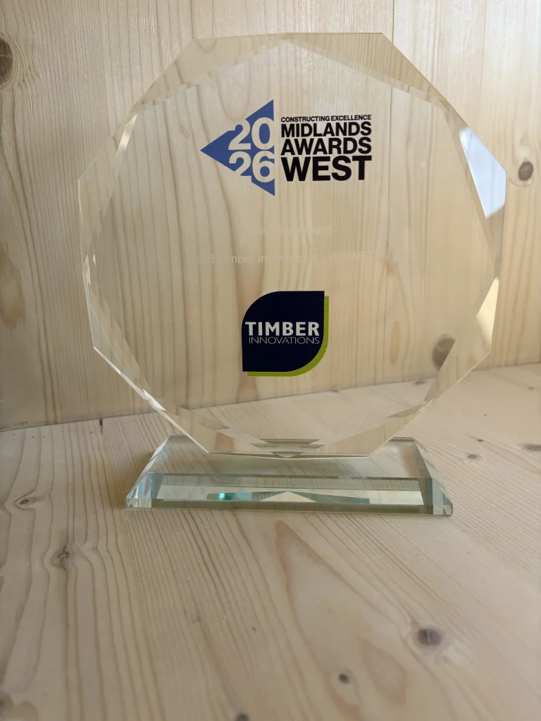 Close up of glass trophy with Timber Innovations logo on
