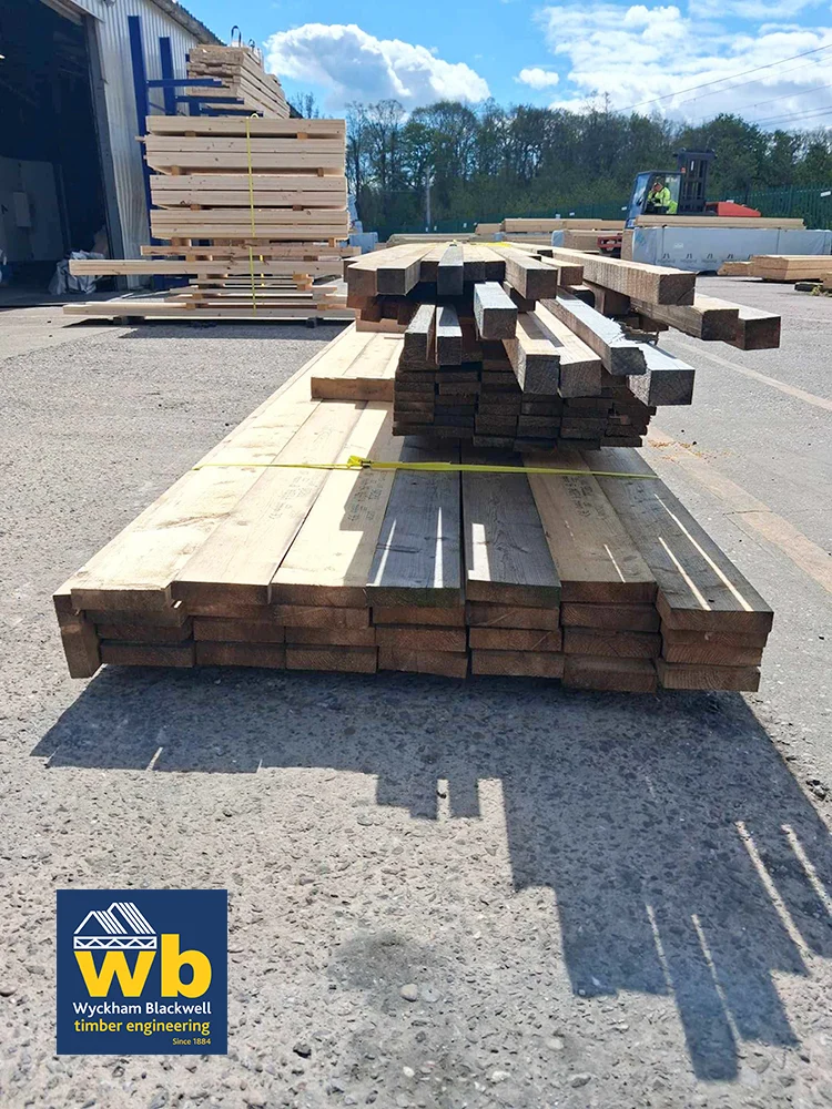Pile of timber outside warehouse