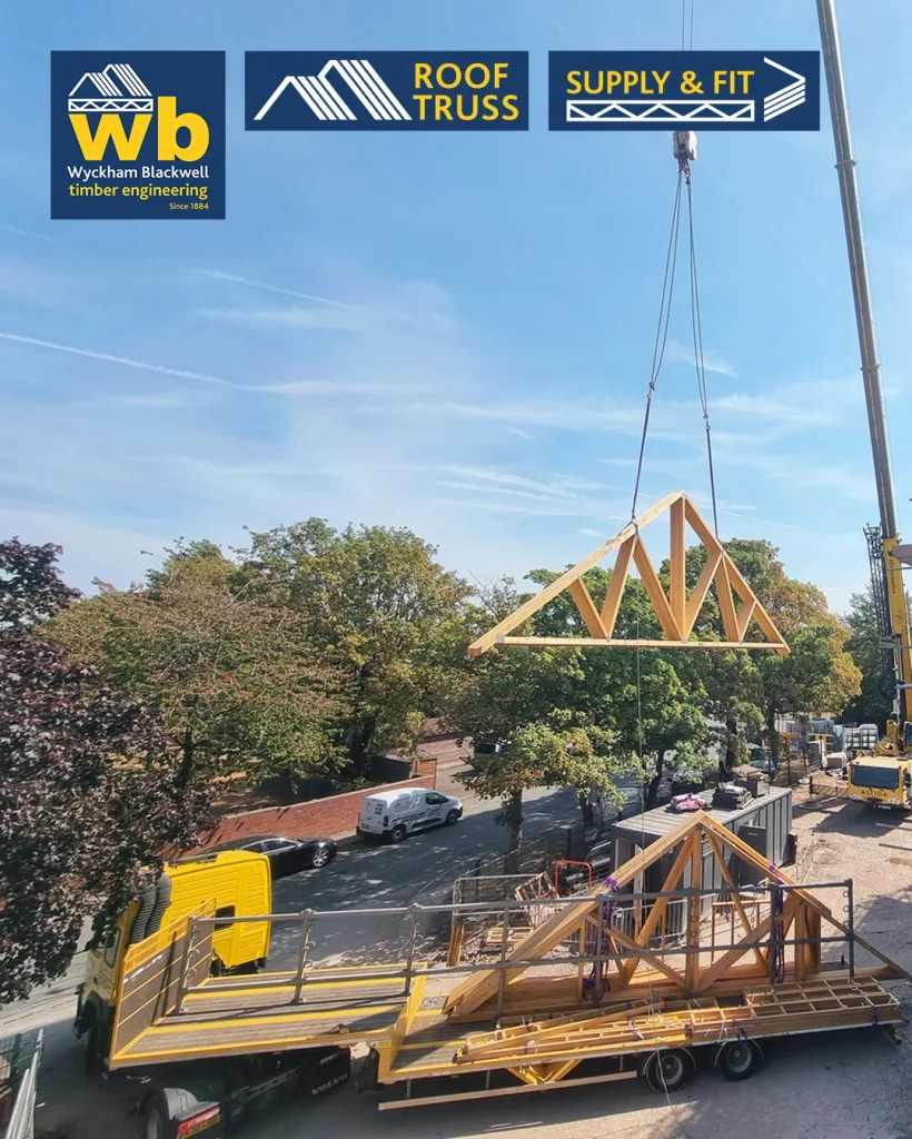 Crane lifts a wooden Roof Truss above a flatbed lorry at a construction site, Wyckham Blackwell logos at top.